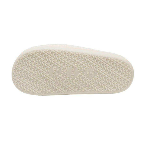 Off-white rubber sole of euphoria slippers with textured triangular pattern and embossed smiley face brand markings to stay warm
