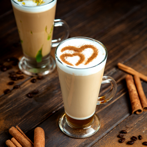 A tall clear glass mug from euri latte glasses set of 4 filled with creamy latte topped with frothy milk and cinnamon heart
