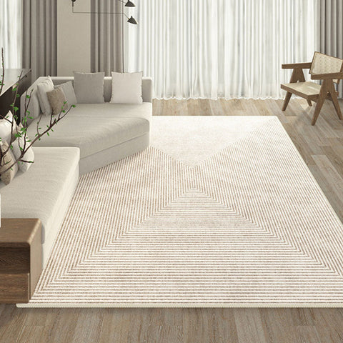 Beige evitany living room rug with a geometric pattern of concentric offset triangles in lighter beige hues
