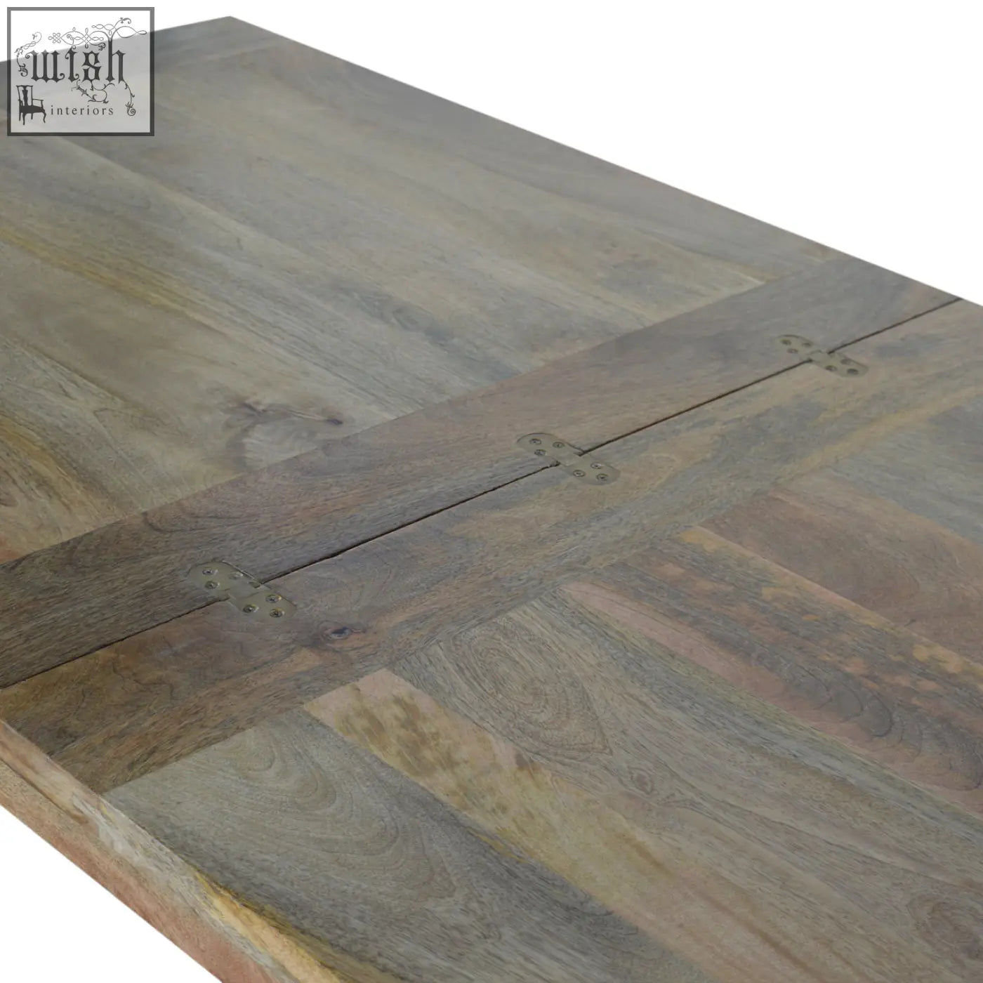Extendable butterfly dining table in grayish-brown mango wood with oak finish and visible grain patterns