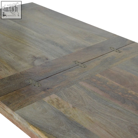 Extendable butterfly dining table in grayish-brown mango wood with oak finish and visible grain patterns
