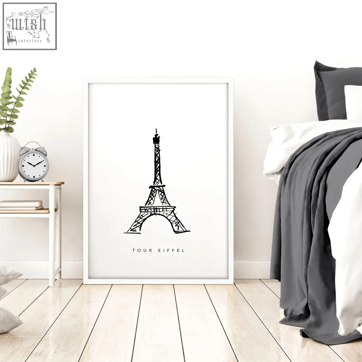 White-framed extra large wall art featuring a black and white illustration of the eiffel tower in minimalist style