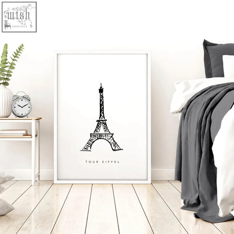 White-framed extra large wall art featuring a black and white illustration of the eiffel tower in minimalist style
