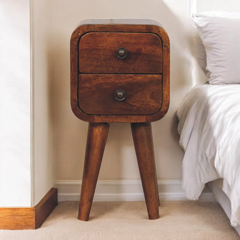 Extra mini curved chestnut bedside table with rustic dark brown wood grain, two drawers, tapered legs, and black metal knobs