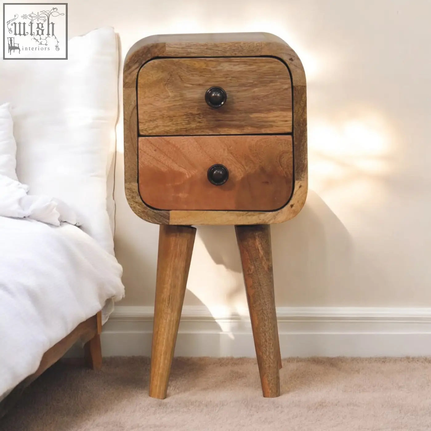 Extra mini curved oak-ish bedside table with mango wood, two drawers with black knobs, and tapered legs