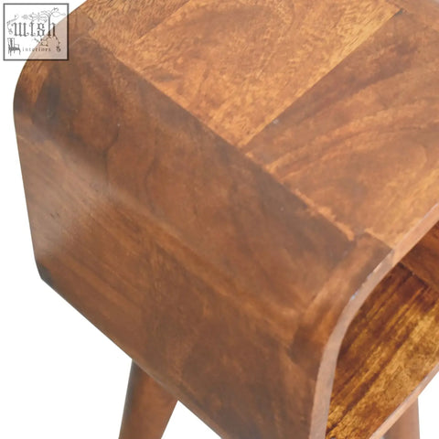 A warm medium-brown wooden extra mini minimalist open curved chestnut bedside table with smooth curved top and visible grain