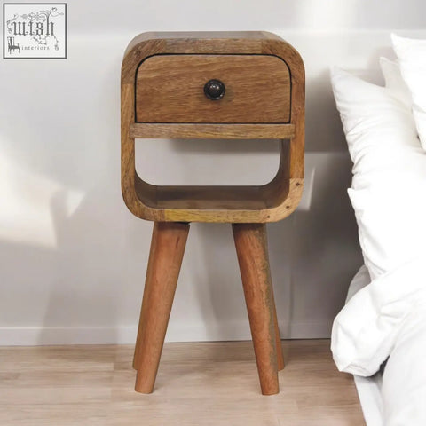 A rustic extra mini oak-ish curve lower bedside table with natural oak finish, one drawer, and dark metal knob