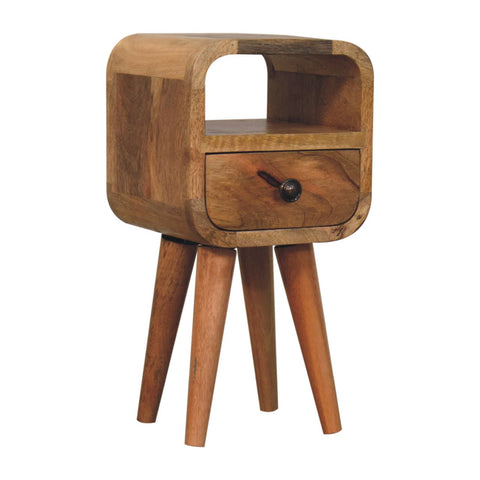 A rustic oakish wooden extra mini bedside table with a curved top, open slot, single drawer, and tapered legs