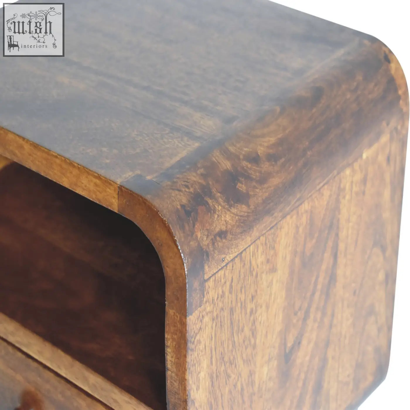 Dark brown curved nightstand made of solid mango wood with visible grain patterns for bedside use