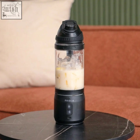 Black f500 portable blender with transparent container filled with iced drink and ice cubes for easy blending on the go