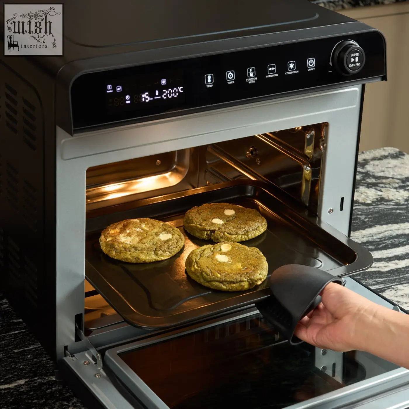 Black and silver super oven pro 30l digital air fryer oven baking three golden cookies at 200°c with digital display