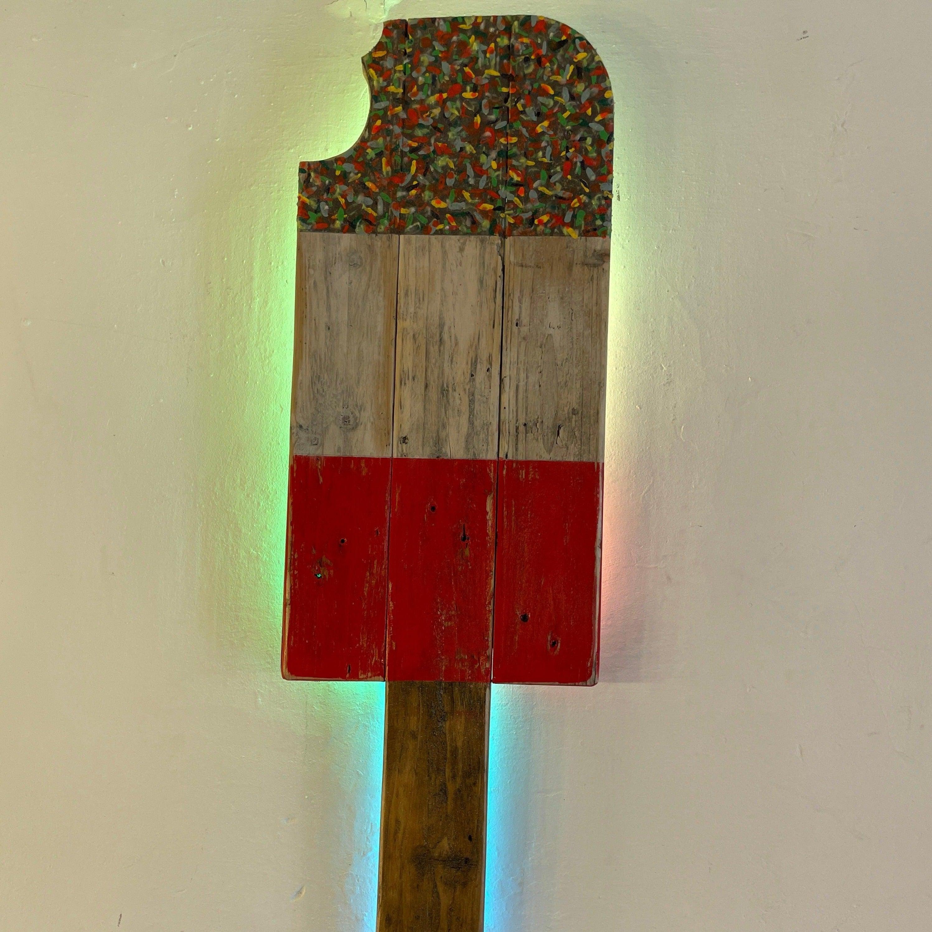 Fab lolly reclaimed wood popsicle wall art with colour changing led, colorful speckled top, and red painted body