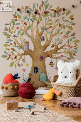 White fluffy bear pillow nestled in a wicker chair with fairy tree house wall decal and magical wildflower garden design