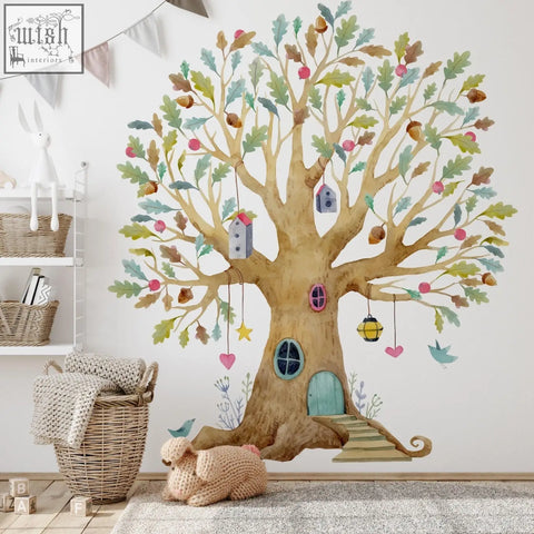 Whimsical fairy tree house wall decal with tan trunk green leaves pink apples and teal door in watercolor style