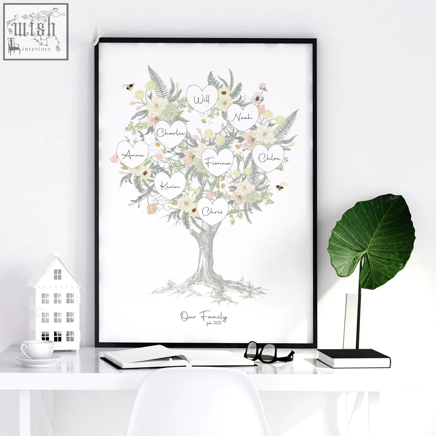 A personalized family tree artwork print with floral leafy branches and pastel heart name tags in a black frame