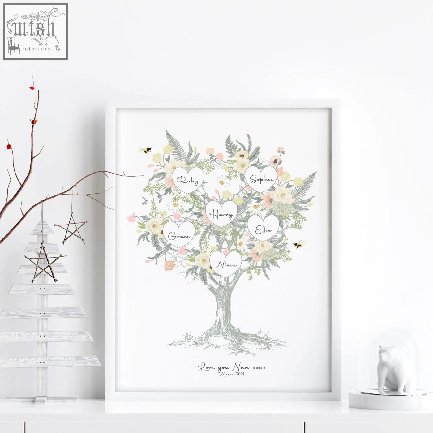 A framed family tree artwork with delicate watercolor flowers greenery and heart-shaped name labels like ruby sophie harry ellie grace niam