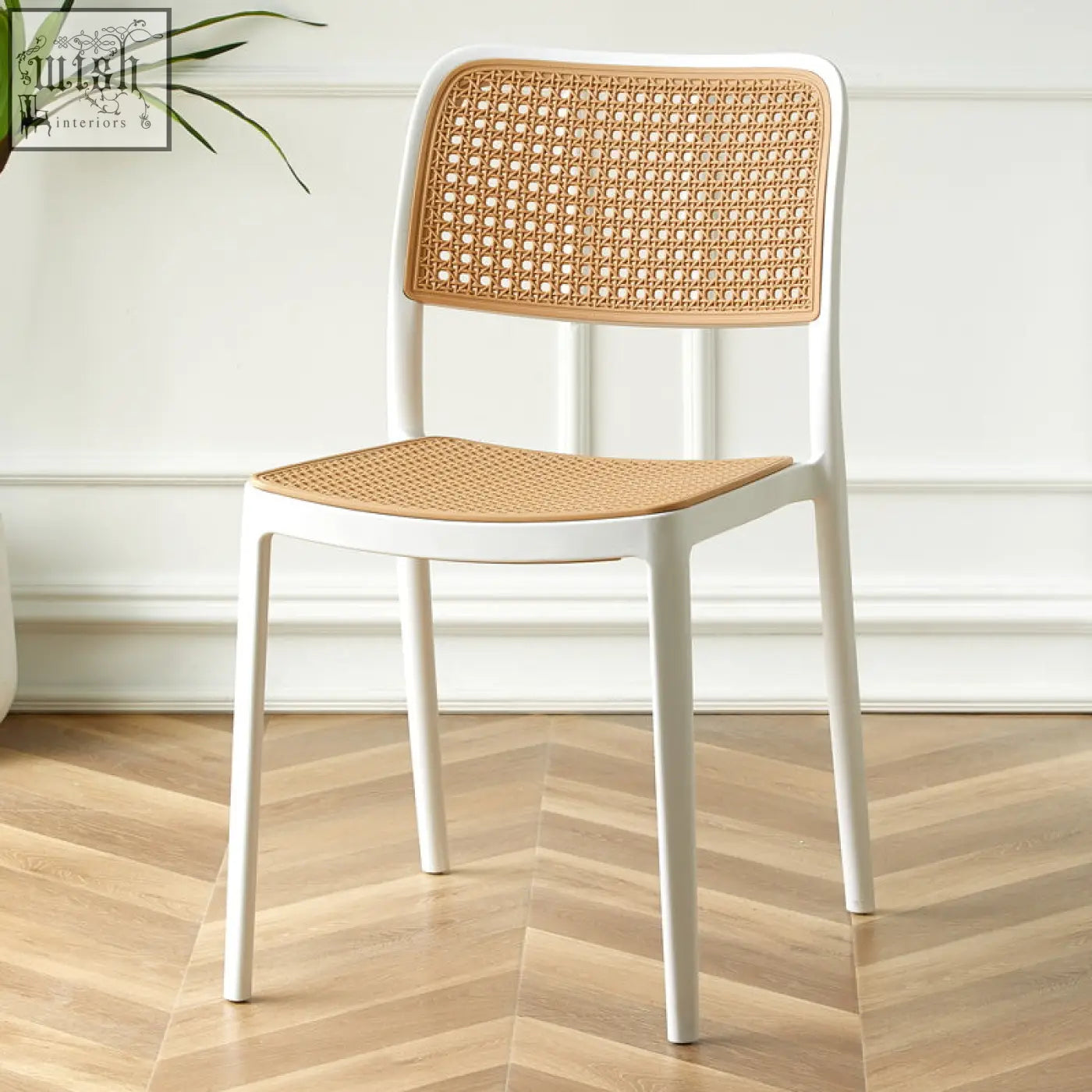 White fanny dining chair with woven cane back and seat perfect for stylish dining spaces