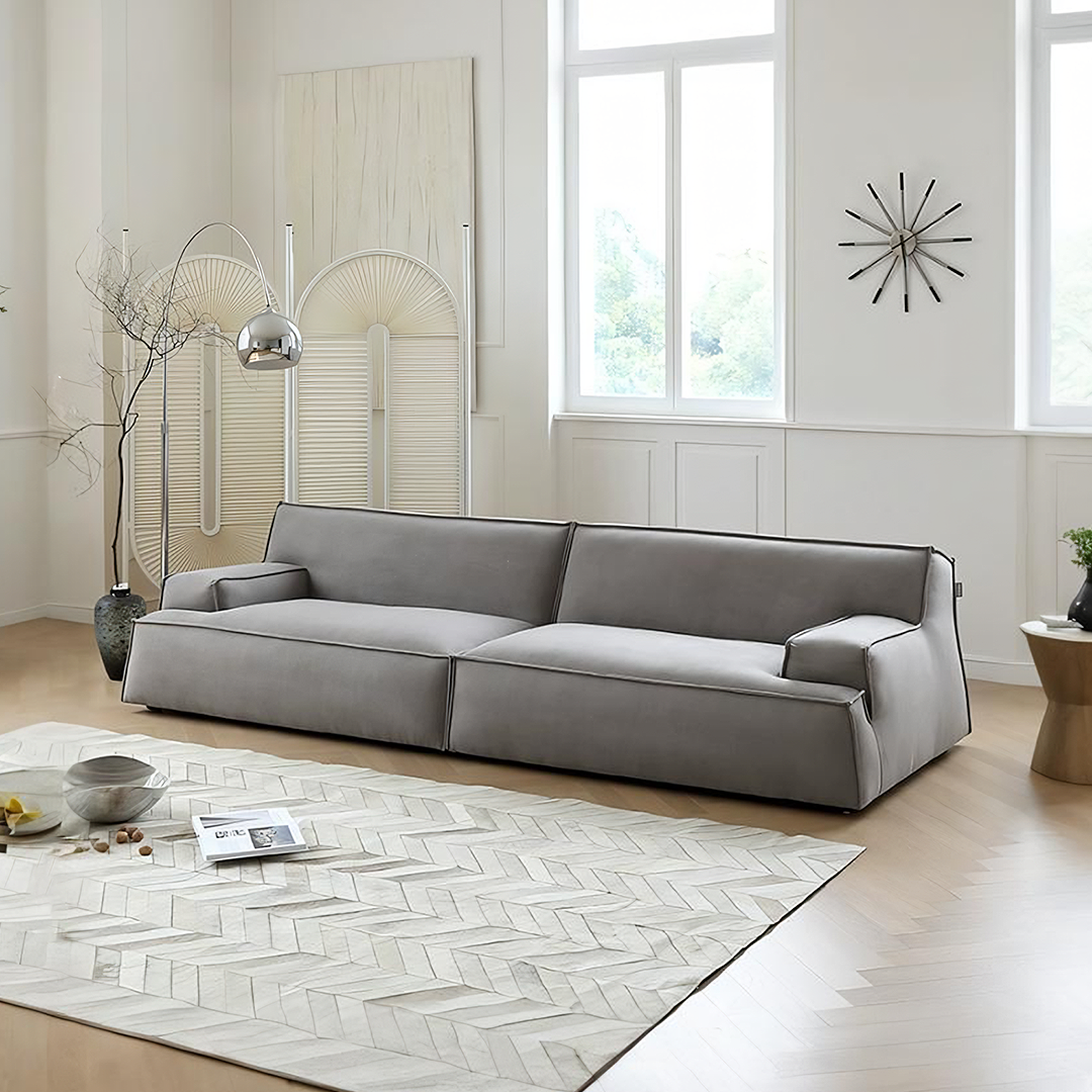 Modern gray suede fanny two seater sofa with clean lines and minimalist design in fabric upholstery