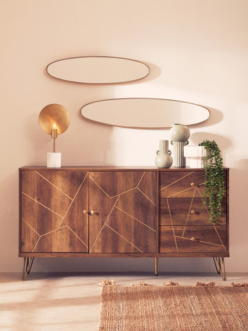 A modern wooden sideboard with geometric gold inlay and metal legs displayed next to the fara white vase