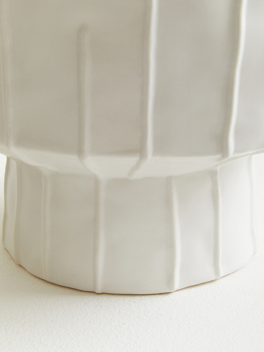 A sleek off-white ceramic fara white vase with a fluted geometric design perfect for home decor