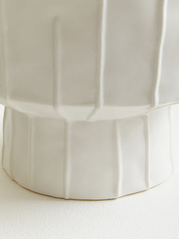 A sleek off-white ceramic fara white vase with a fluted geometric design perfect for home decor