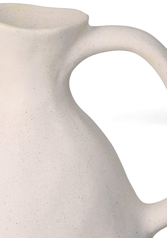 Cream-colored speckled clay jug with smooth curved handle perfect for farmhouse style decor and everyday use