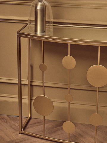 Farran champagne gold finish console table with mirror top and gold-toned metal circular disc accents