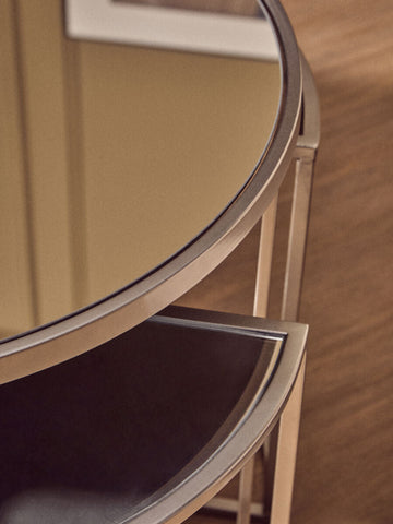 Circular mirrored tabletop with polished chrome frame and dark brown leather shelf from farran set silver finish tables