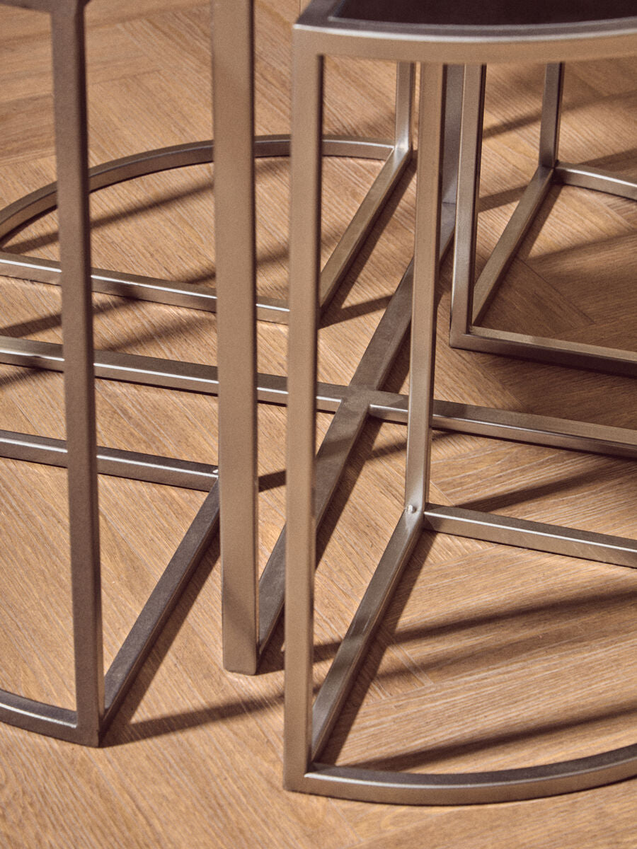 Modern geometric side table from the farran set with a sleek silver finish frame and dark glass top silver finish tables