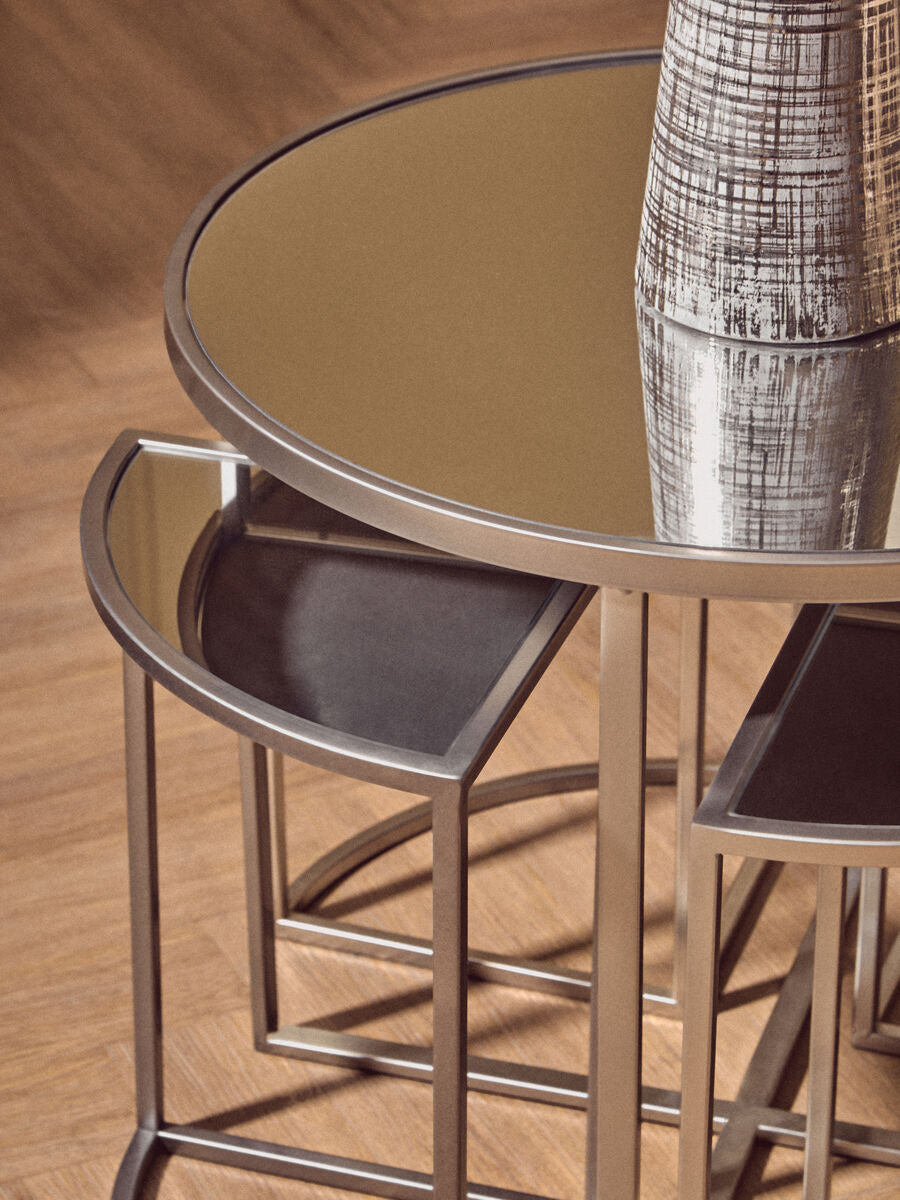 Set of three nested round silver finish tables with mirrored tops and sleek metallic frames from farran set