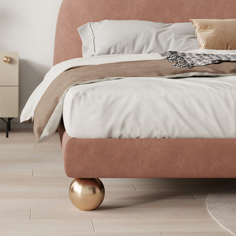 A dusty rose plush fatima bed king size bed with rounded headboard and golden spherical feet perfect for girls