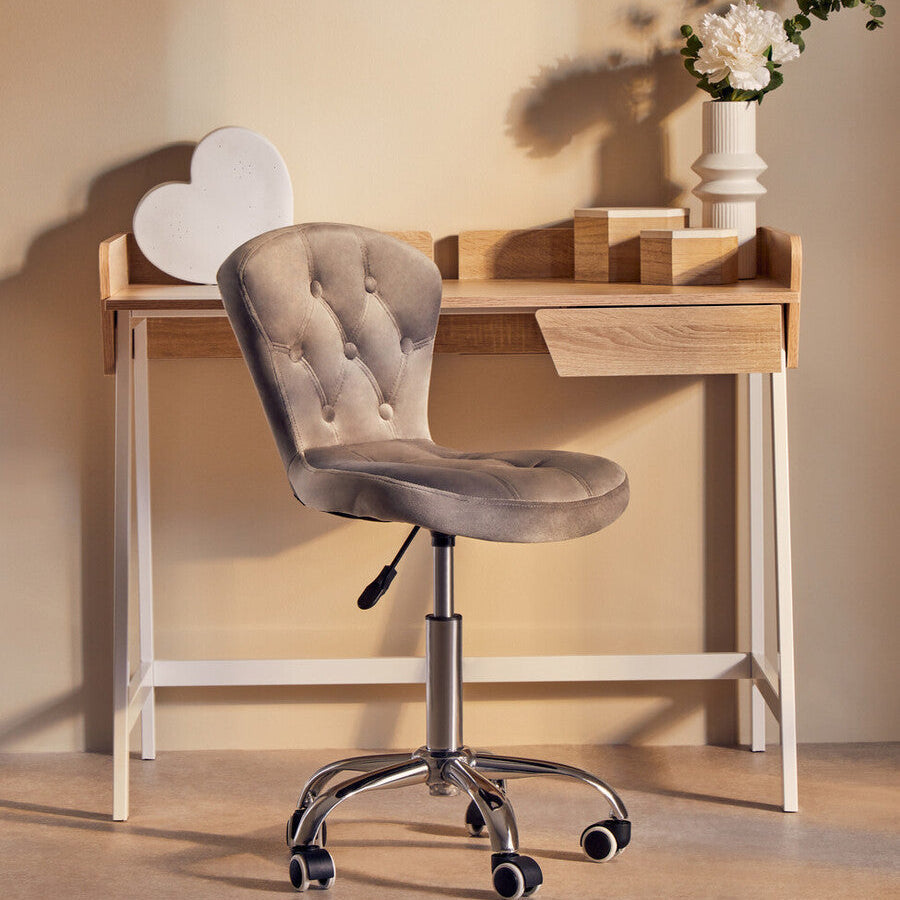 Beige tufted velvet office chair with chrome base and casters designed as a grey velvet buttoned home office chair