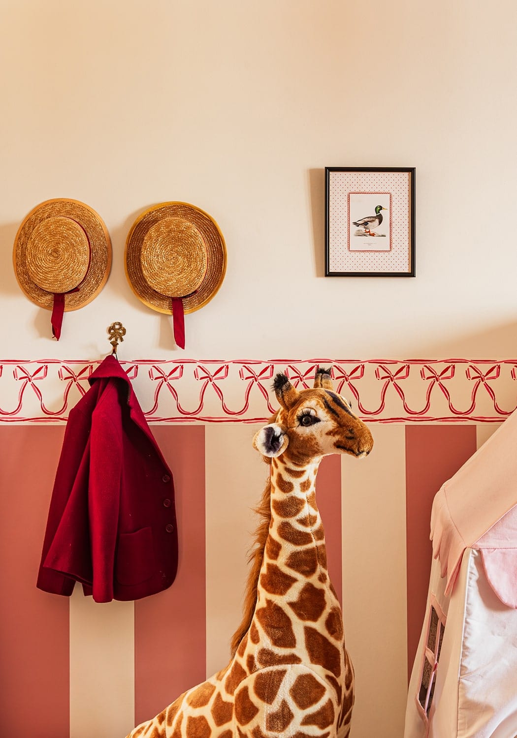 A plush giraffe figurine with tan and brown spots made of soft fabric in the feather and grace duck print iii collection