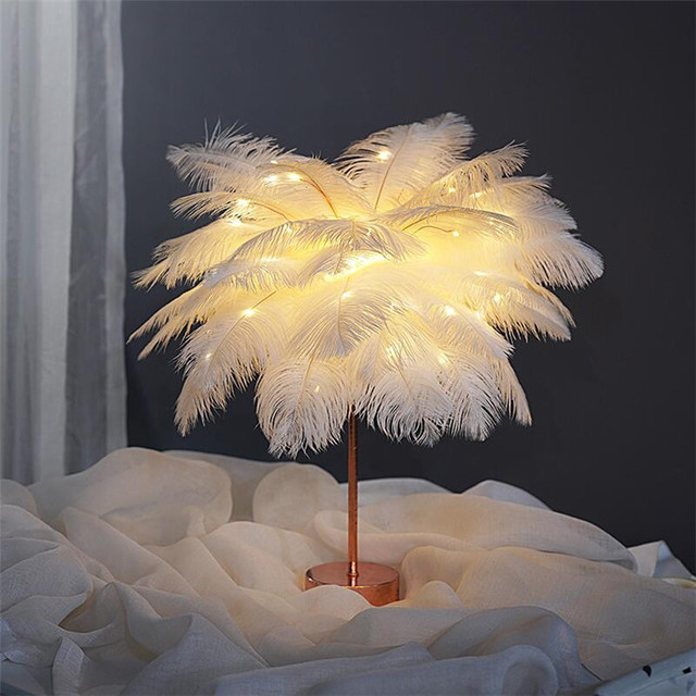 A delicate white feather lamp with warm glowing light, european-style bedside lamp with remote control and power supply