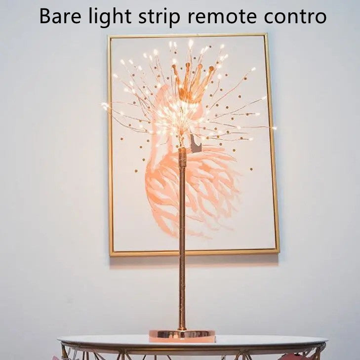 A slender rose gold feather lamp with warm white led lights and power supply ideal for bedroom decoration