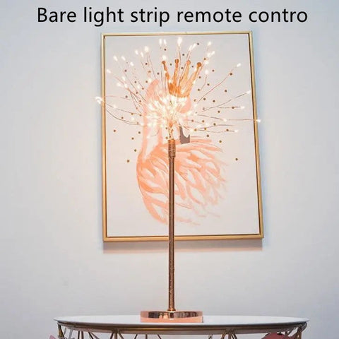 A slender rose gold feather lamp with warm white led lights and power supply ideal for bedroom decoration