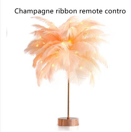 A delicate champagne-colored feather lamp with a slender metallic stand for bedside decoration with power supply