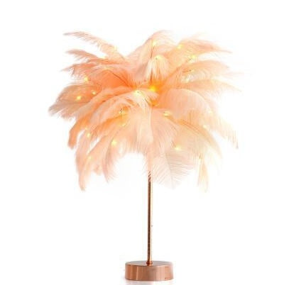 A peach feather lamp with gold stem and wooden base featuring soft lights perfect for bedside decoration with remote control power supply