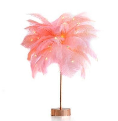 A delicate pink feather lamp with a slender gold stand and power supply perfect for bedroom decoration and remote control use