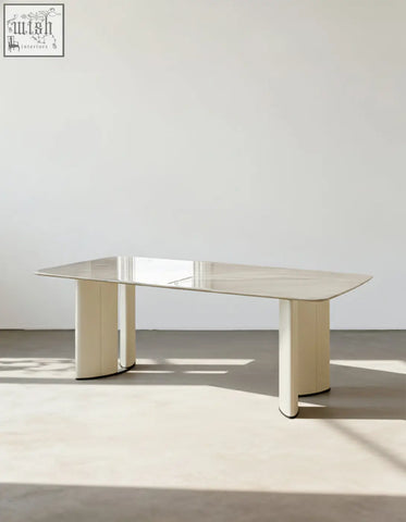 Felicia marble dining table with a sleek polished marble top and cream-colored cylindrical legs modern minimalist dining table