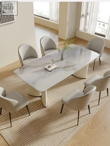 Modern felicia marble dining table with sleek curved white legs and a marble top for stylish dining use
