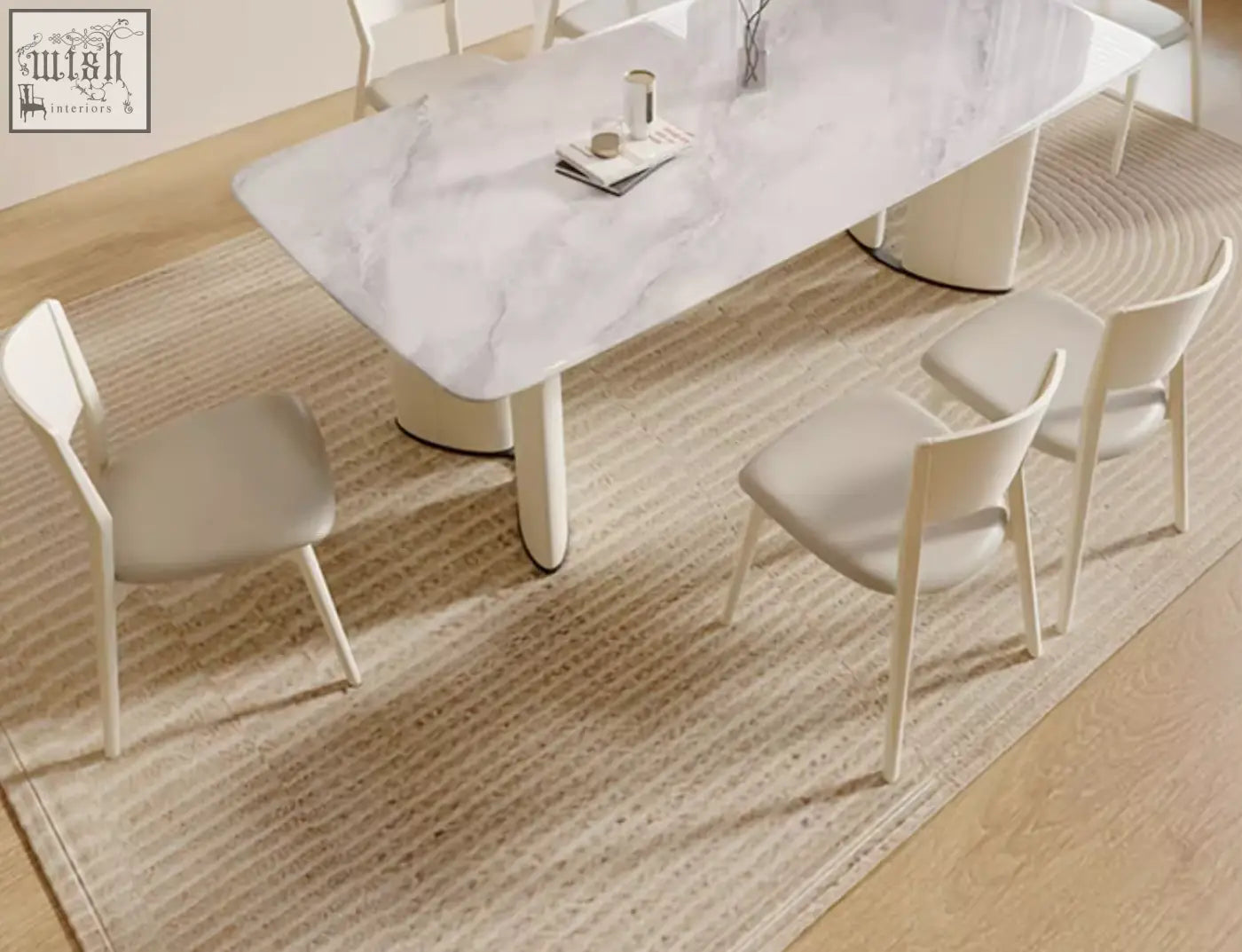 Modern white felicia marble dining table with sleek cylindrical legs and minimalist marble dining table design