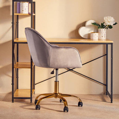 Gray velvet office chair with gold finish base and casters featured alongside fenwick canister with gold finish lid