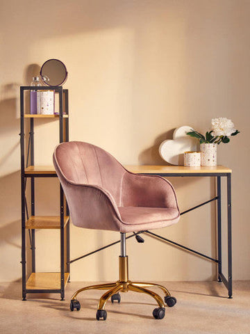 Pink velvet office chair with gold finish base and casters next to fenwick canister with gold finish lid