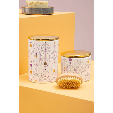 White fenwick canister with gold finish lid featuring purple and mustard yellow geometric circle and dot pattern