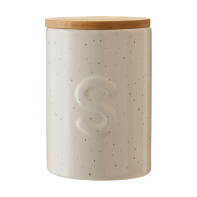 Cream-colored speckled ceramic fenwick sugar canister with natural wood lid and embossed s for storing sugar