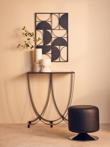Black metal geometric wall art with circular patterns complementing the fia white planter for stylish decor