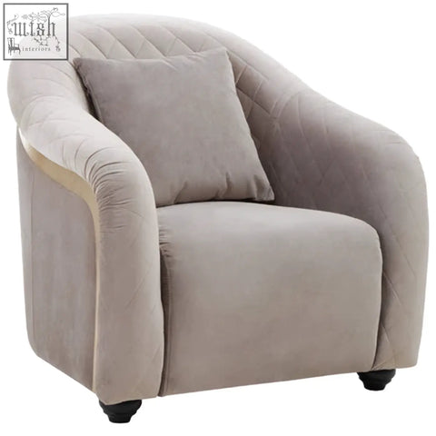 Beige velvet armchair with tufted upholstery and matching cushion in the style of fifi grey velvet chair