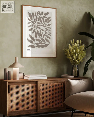 A minimalist fika art print featuring gray acrylic paint leaf patterns on white paper in a wooden frame