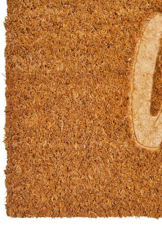 Brown coir doormat with light beige embossed letter o made from natural coir fibers for outdoor use